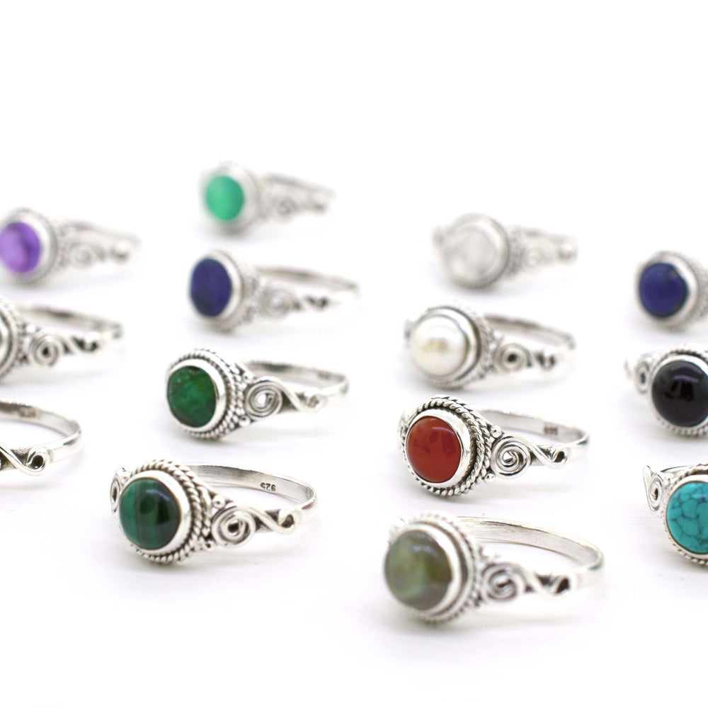 
                  
                    A Gemstone Circle Ring With Rope Border And Swirl Design, perfect for Santa Cruz style.
                  
                
