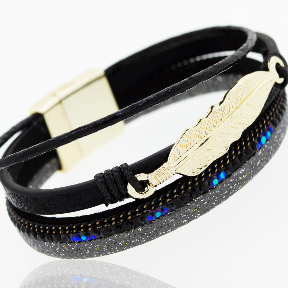 
                  
                    A Super Silver black faux leather bracelet with a gold feather charm.
                  
                