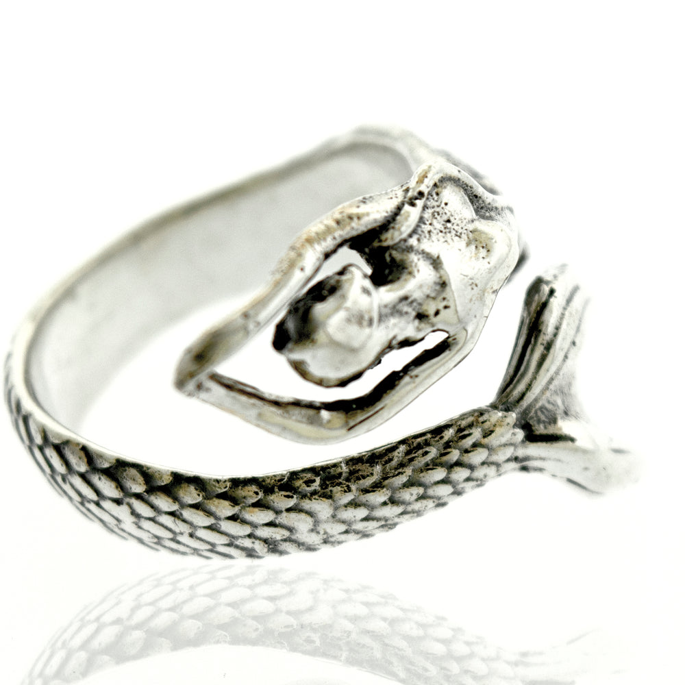A Sterling Silver Adjustable Mermaid Ring with a stone accent, resting on a white surface.