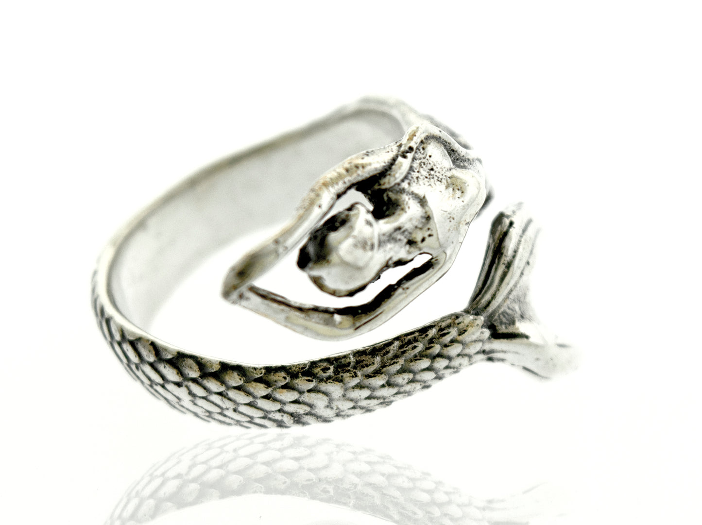 A Sterling Silver Adjustable Mermaid Ring with a stone accent, resting on a white surface.