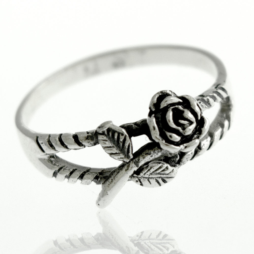 A Sterling Silver Rose Ring adorned with a delicate rose, showcasing its floral charm.