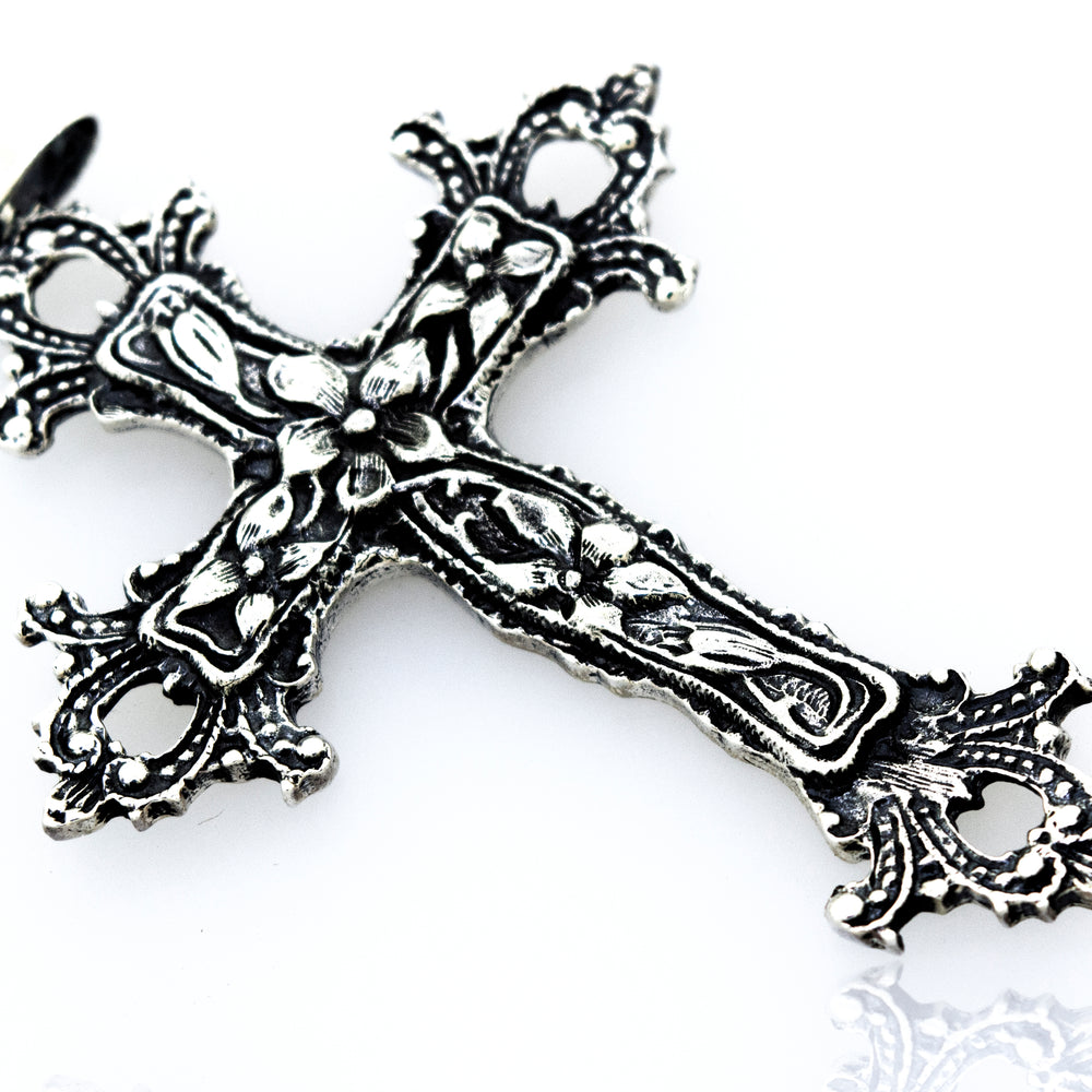 A vintage style, Medieval Floral Cross Pendant, serving as a statement centerpiece on a white surface.