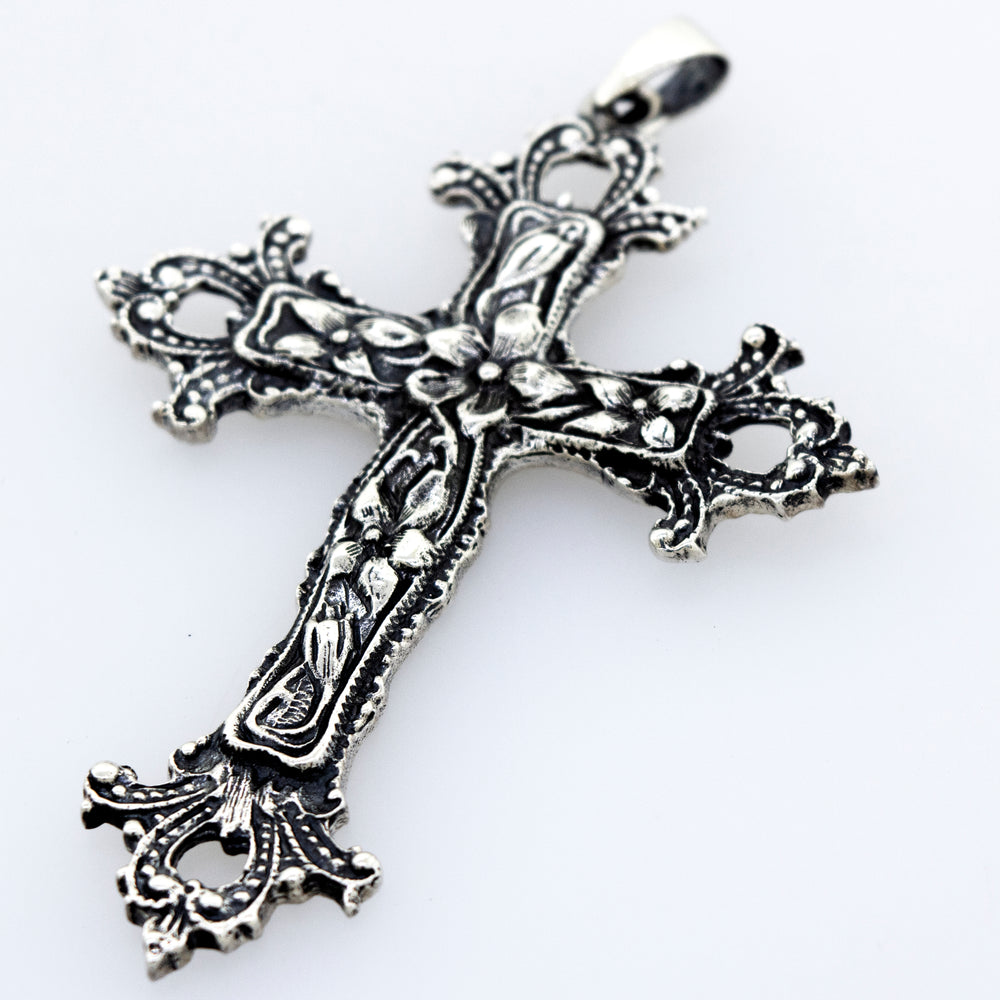 An ornate Medieval Floral Cross Pendant, a statement centerpiece on a white surface by Super Silver.