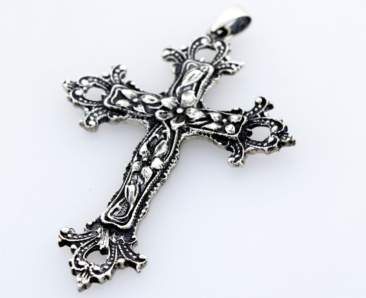 An ornate Medieval Floral Cross Pendant, a statement centerpiece on a white surface by Super Silver.