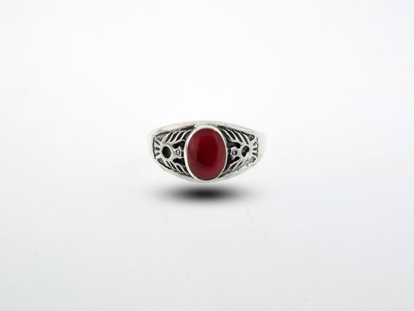 A Native American Inspired Ring With Phoenix Design with a red stone.