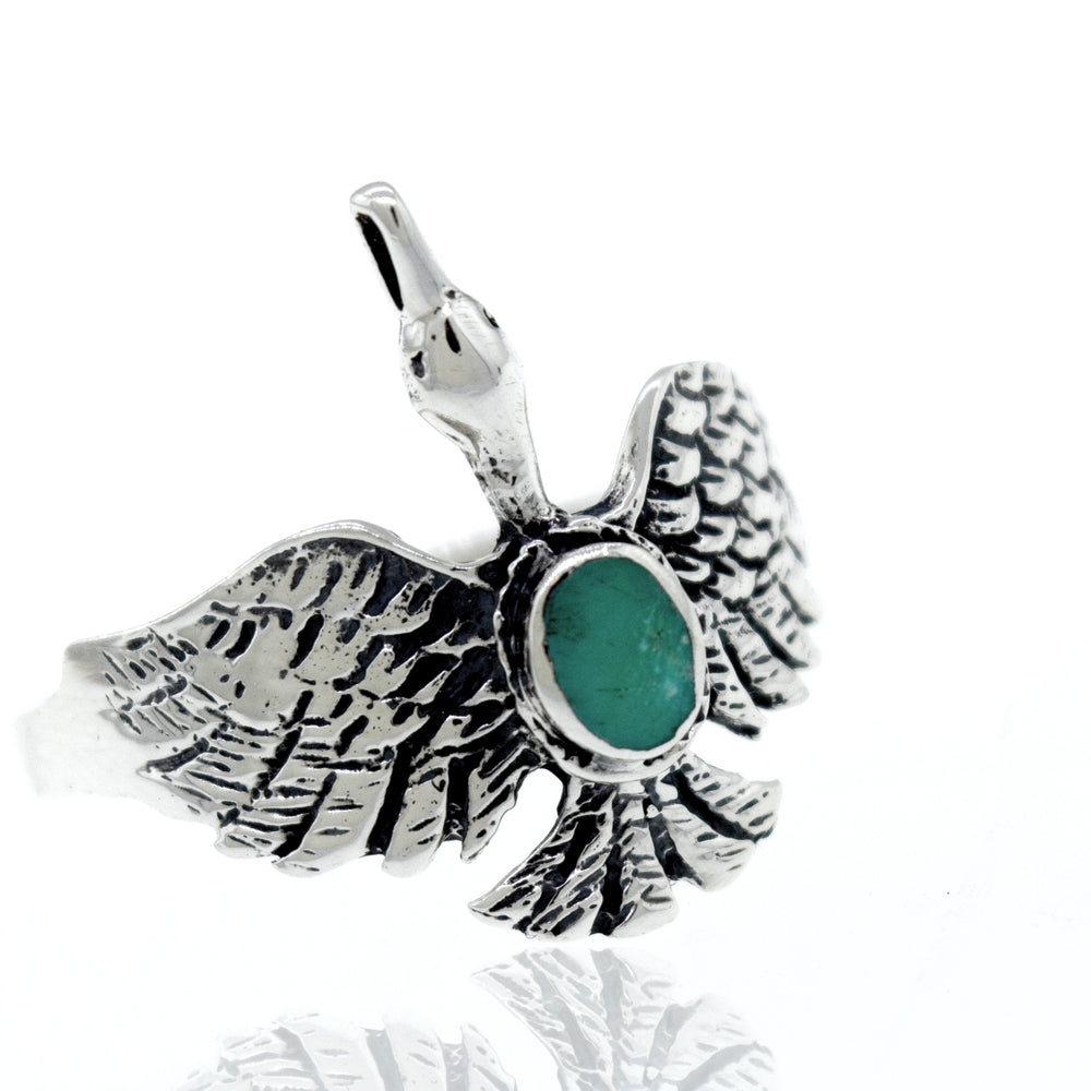 
                  
                    A silver Swan Ring with an oval emerald stone inspired by nature.
                  
                