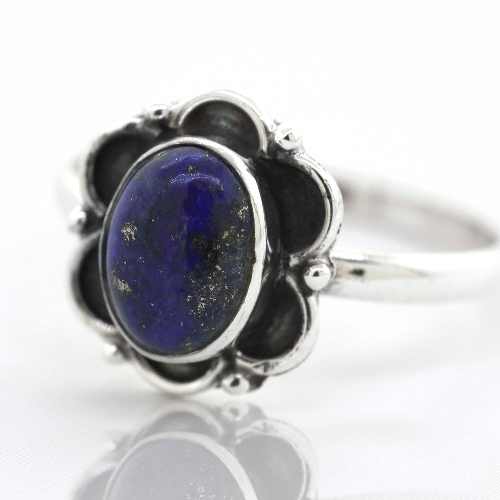 
                  
                    A Gemstone Ring With Oxidized Flower Design with a lapis cabochon stone in the center.
                  
                