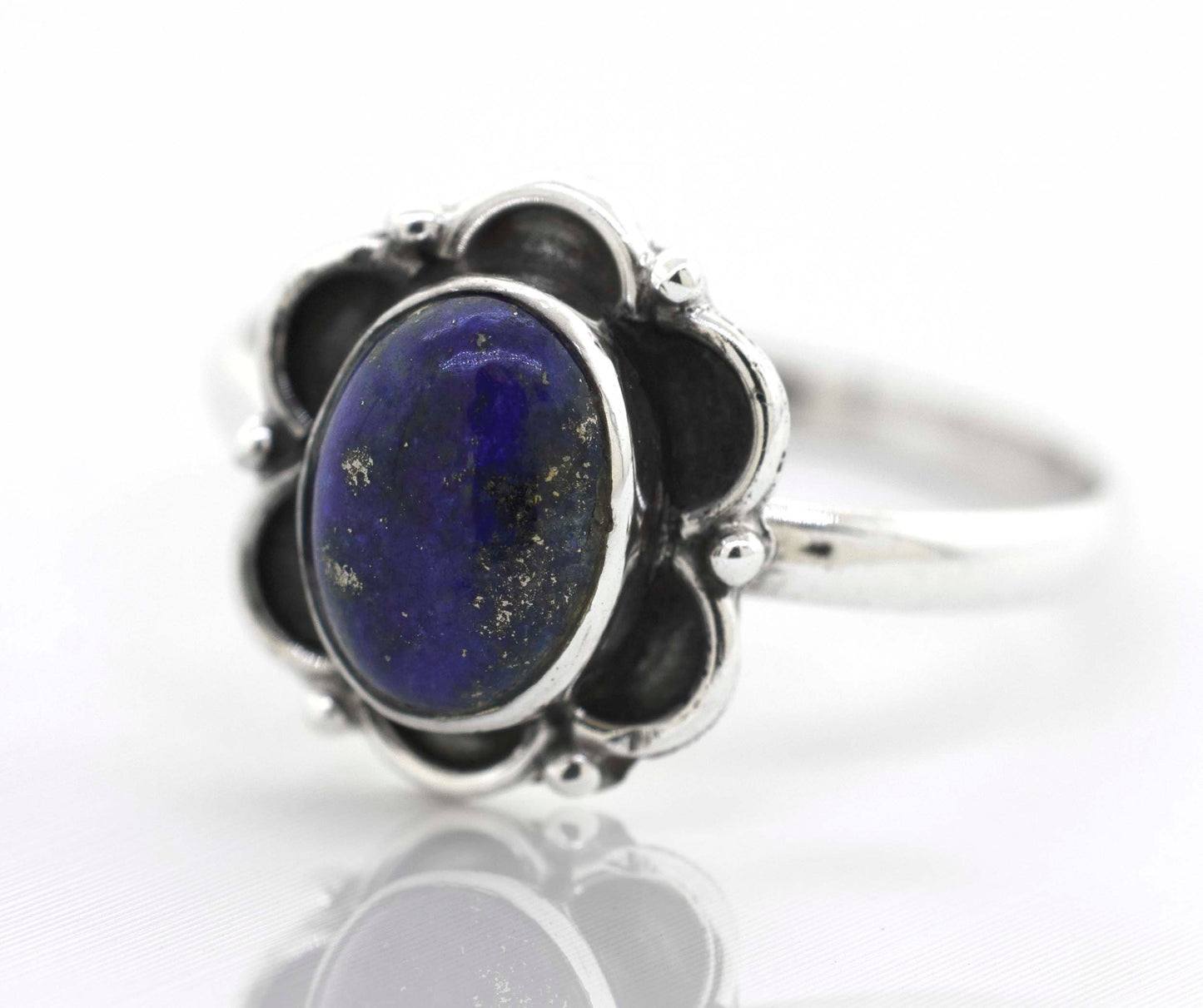 
                  
                    A Gemstone Ring With Oxidized Flower Design with a lapis cabochon stone in the center.
                  
                