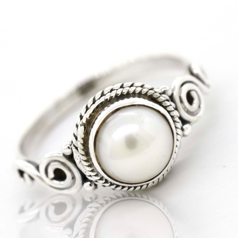 
                  
                    A gemstone circle ring with rope border and swirl design.
                  
                