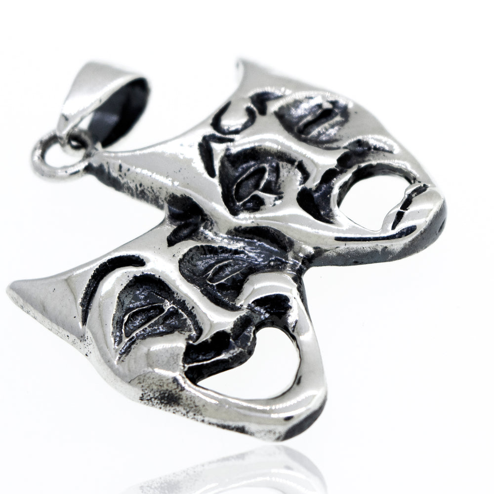 
                  
                    A Super Silver Laugh Now Cry Later pendant with two theatre masks engraved on it.
                  
                