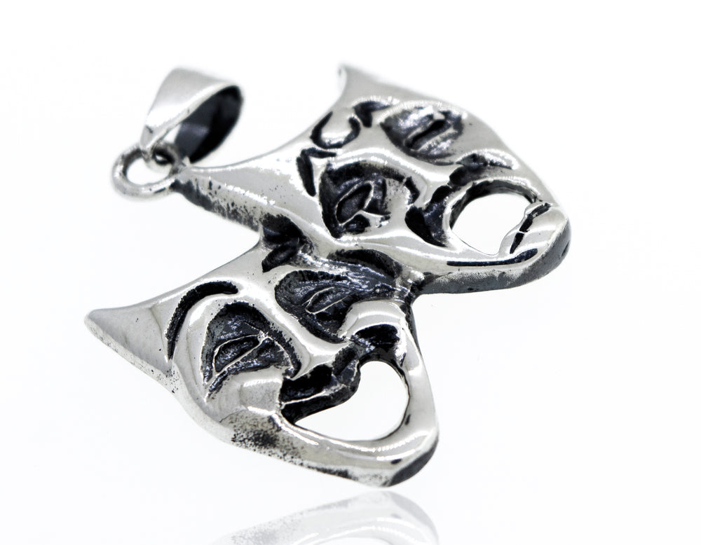 
                  
                    A Super Silver Laugh Now Cry Later pendant with two theatre masks engraved on it.
                  
                