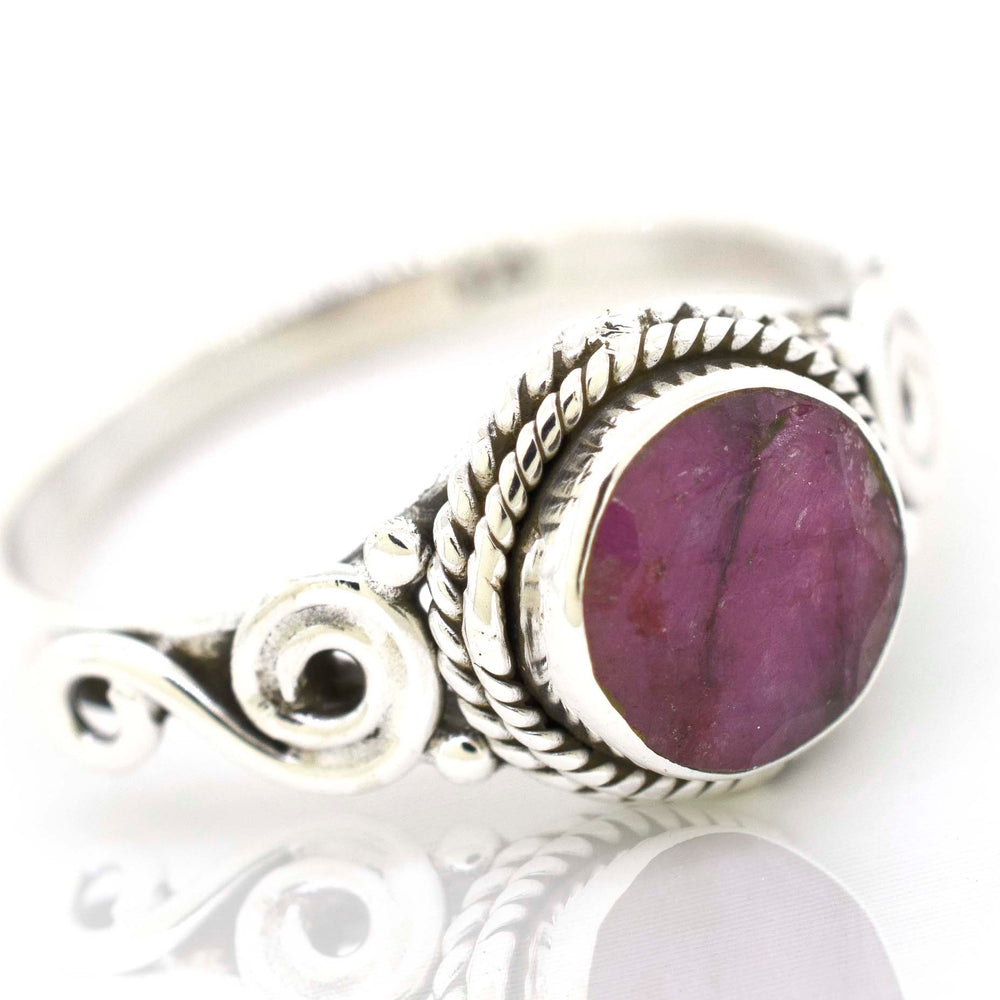 
                  
                    A bohemian-inspired Super Silver Gemstone Circle Ring With Rope Border And Swirl Design.
                  
                