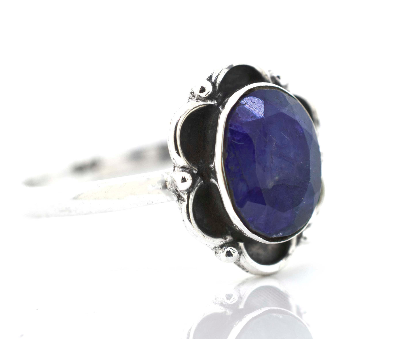 
                  
                    A delicate Gemstone Ring With Oxidized Flower Design by Super Silver with a central blue sapphire stone.
                  
                