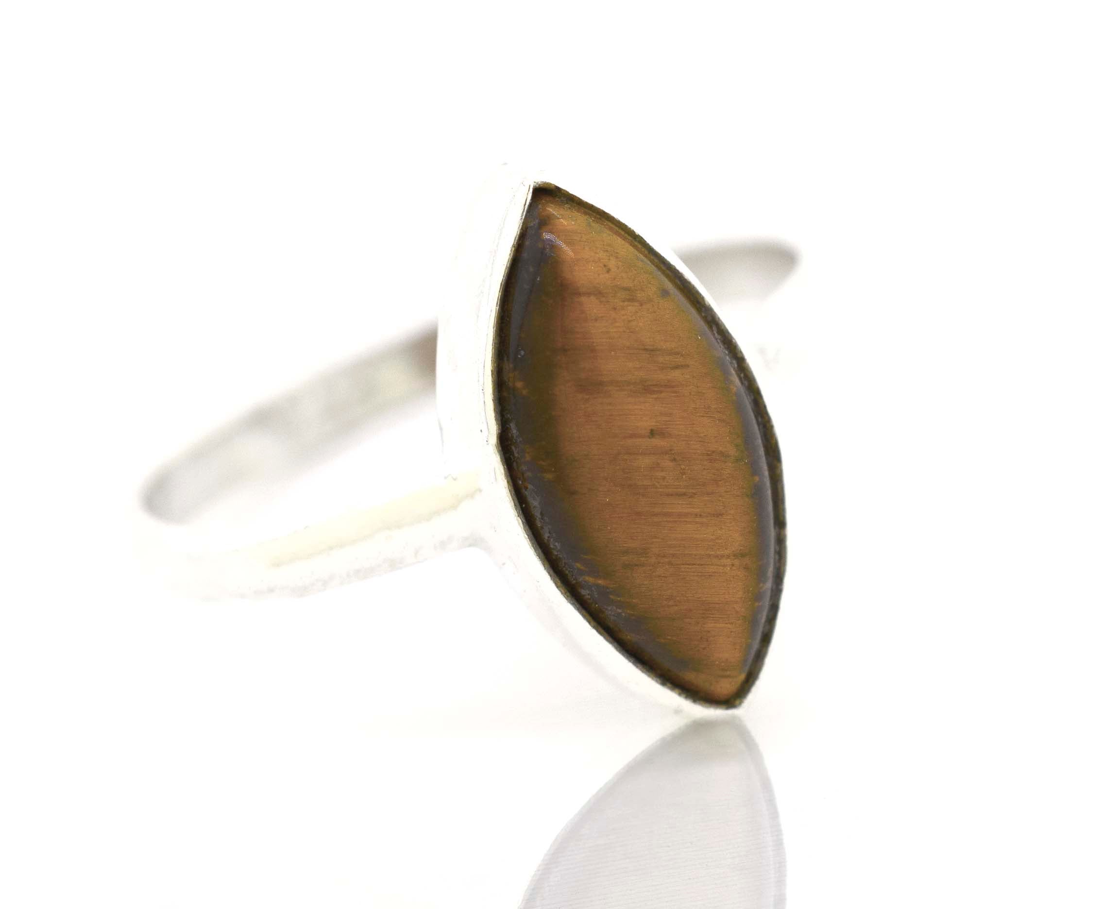 A Super Silver Simple Marquise Shaped Gemstone Ring on a white surface.