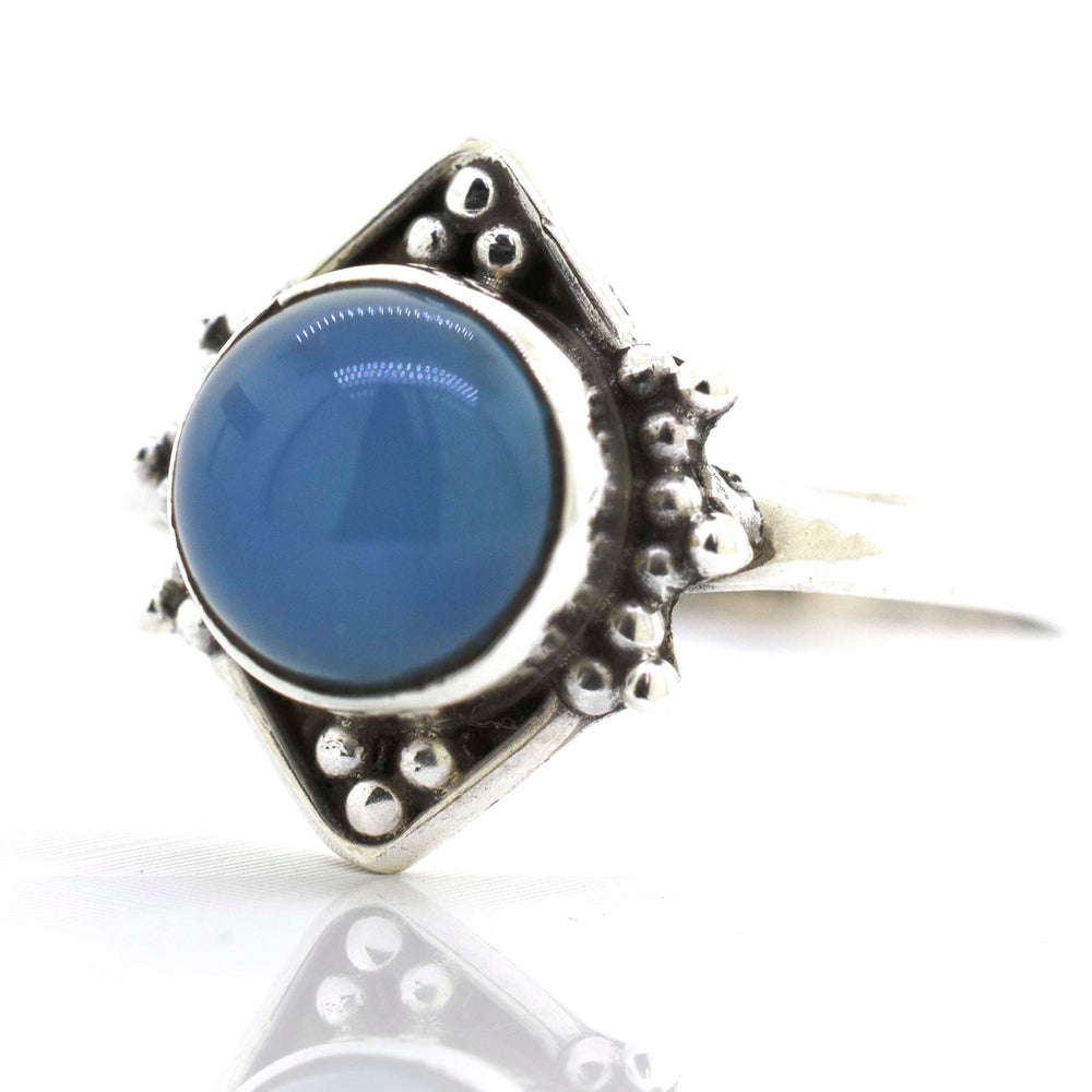 
                  
                    A round gemstone ring with oxidized diamond shape pattern.
                  
                