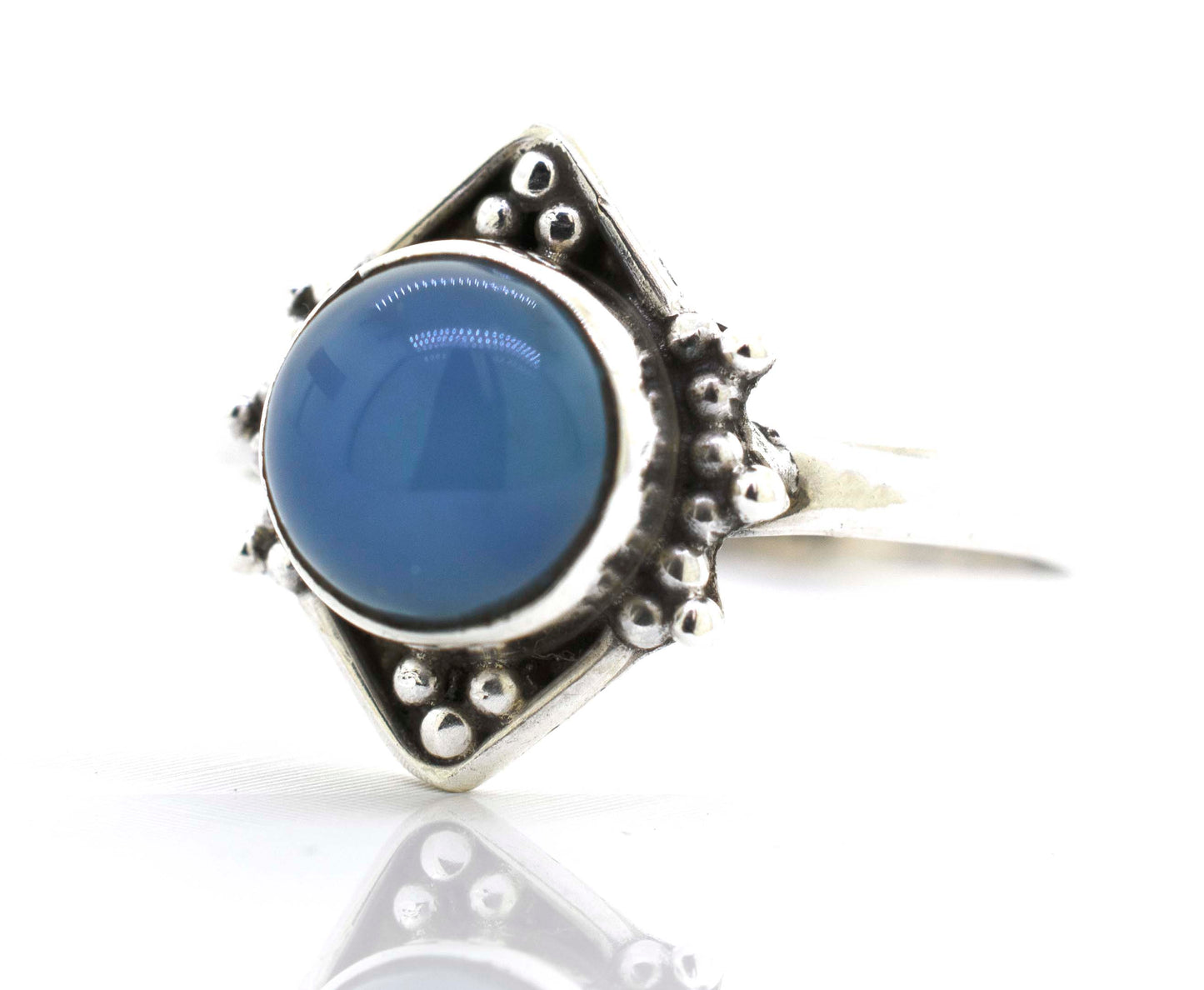 
                  
                    A round gemstone ring with oxidized diamond shape pattern.
                  
                