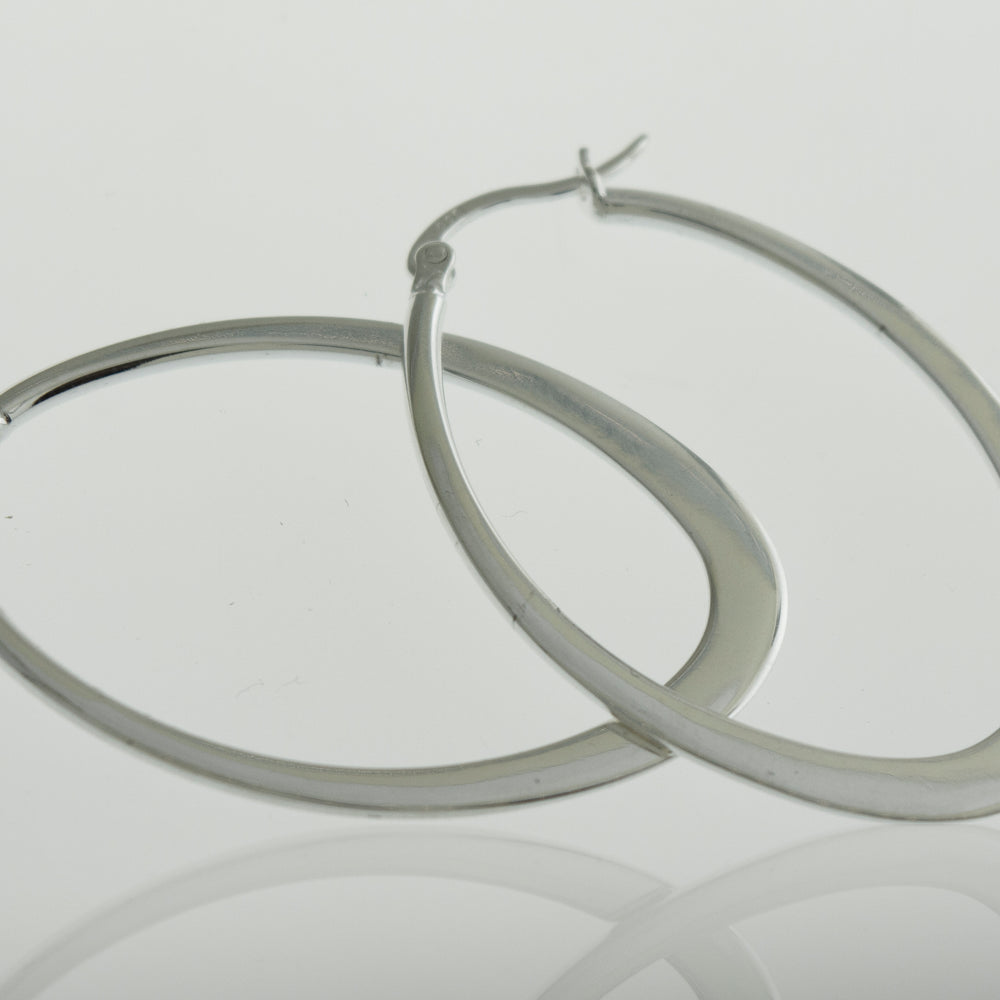 
                  
                    A minimalist pair of Super Silver oval shaped hoop earrings.
                  
                