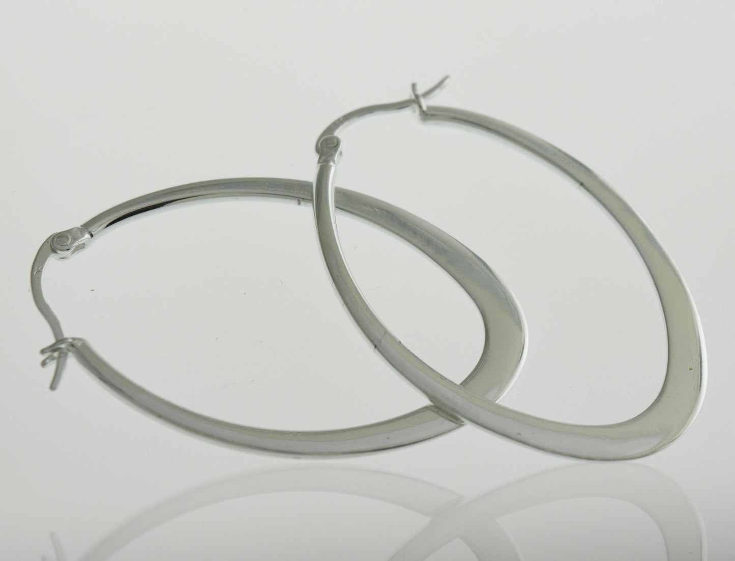
                  
                    A minimalist pair of Super Silver oval shaped hoop earrings.
                  
                
