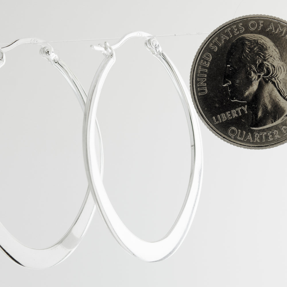 A minimalist pair of Super Silver Oval Shaped Hoops.