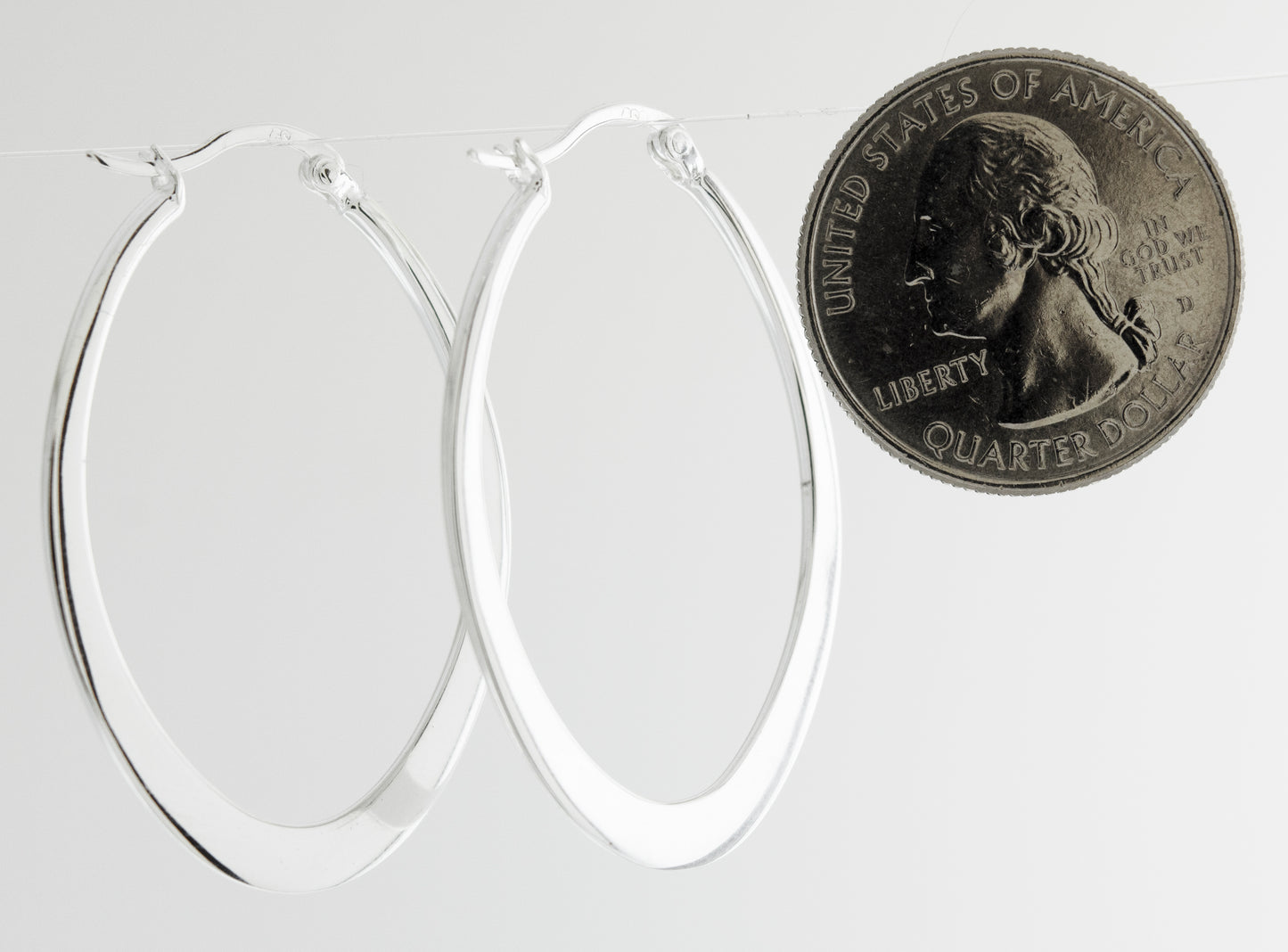 
                  
                    A minimalist pair of Super Silver Oval Shaped Hoops.
                  
                