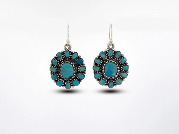 A pair of Super Silver Western Inspired Genuine Turquoise Flower Design Earring Dangle on a white background.