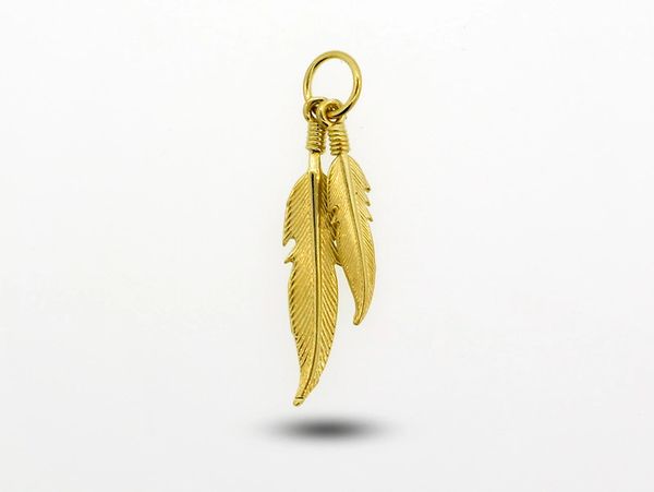 A Super Silver Double Feather Charm with Gold Overlay pendant on a white background.