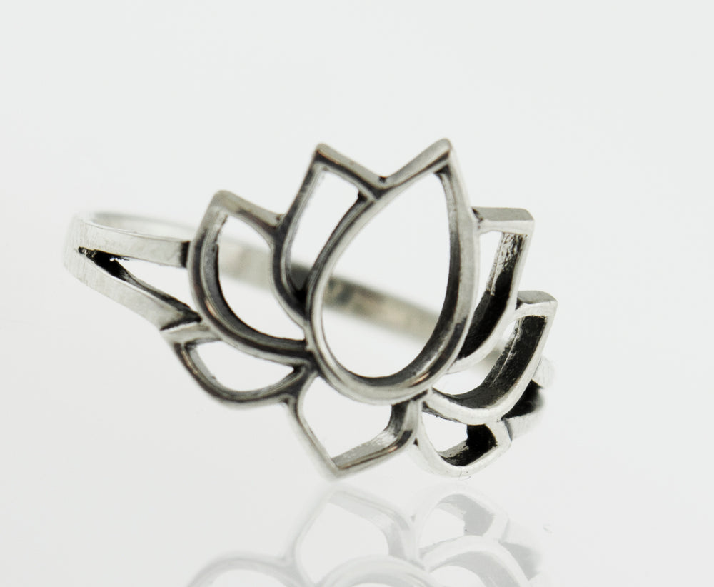A minimalist silver Lotus Outline ring on a modern white surface.