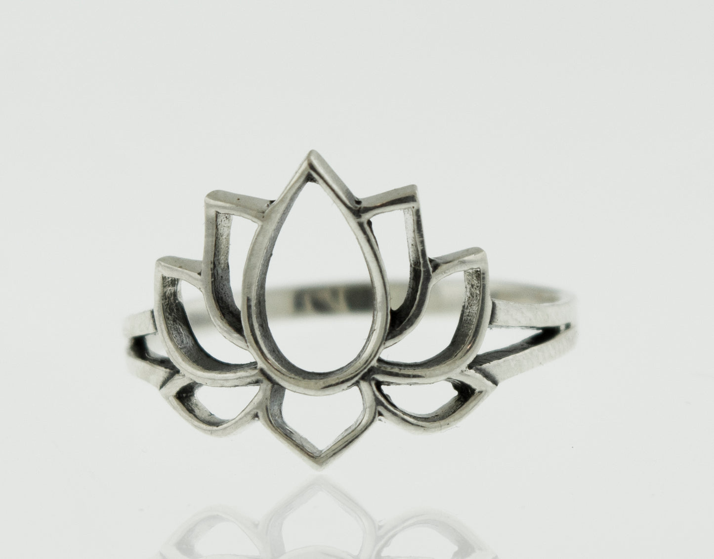 
                  
                    A minimalist silver Lotus Outline ring featuring a delicate lotus flower.
                  
                