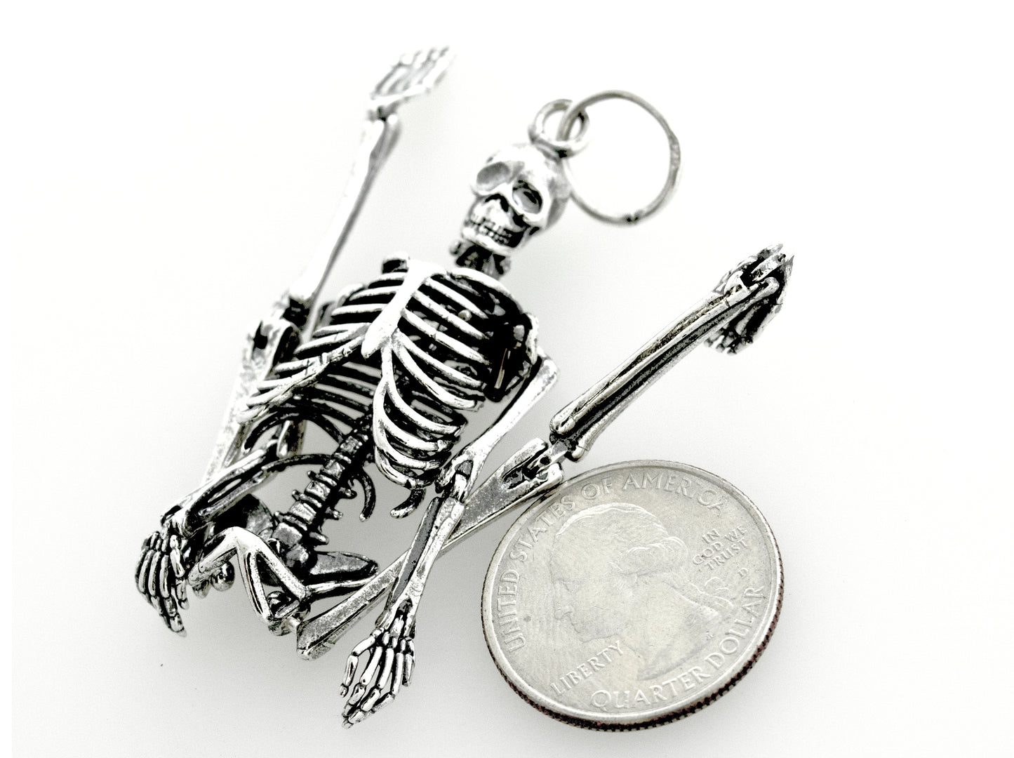 
                  
                    A stylish Super Silver Large Skeleton Pendant paired with a quarter, creating a statement piece.
                  
                
