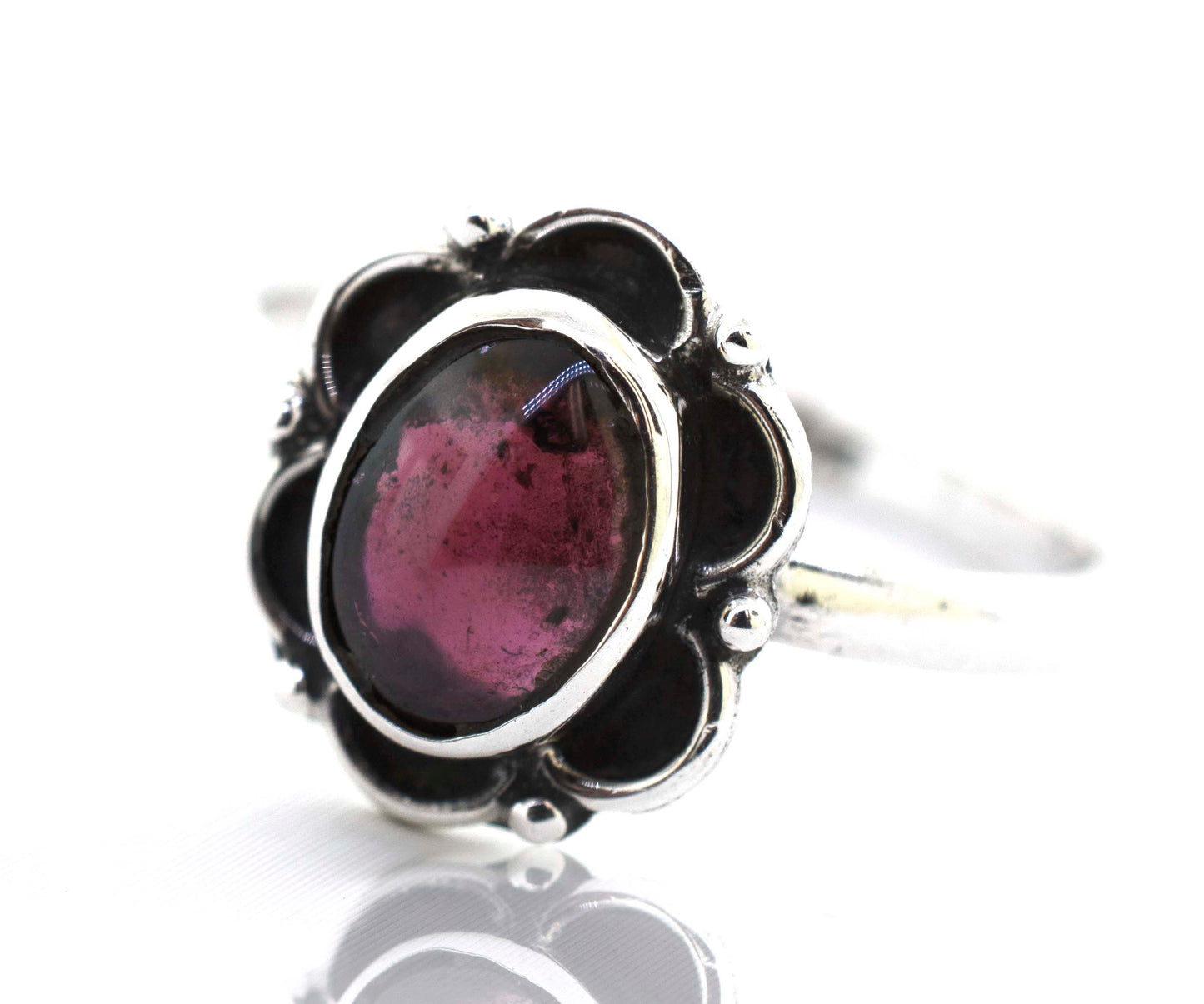 
                  
                    A delicate Super Silver Gemstone Ring With Oxidized Flower Design with a central pink tourmaline gemstone.
                  
                