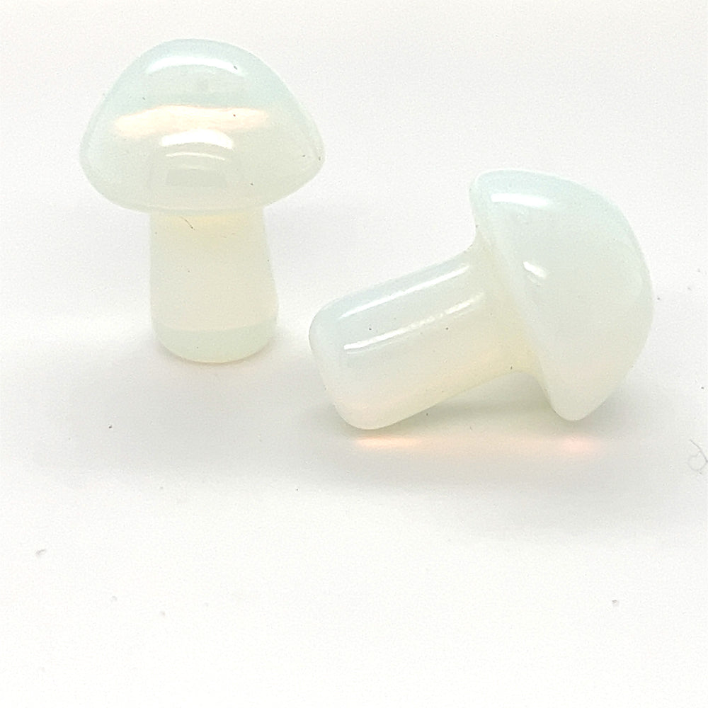Two white plastic Opalite Stone Mushroom plugs on a white surface displaying Super Silver healing properties.