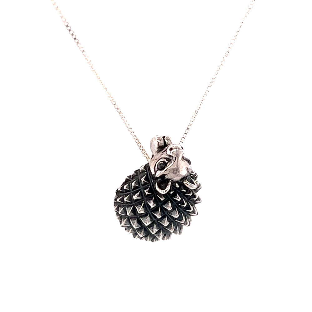 A Super Silver Hedgehog Pendant and Brooch with a black and silver ball on a chain.