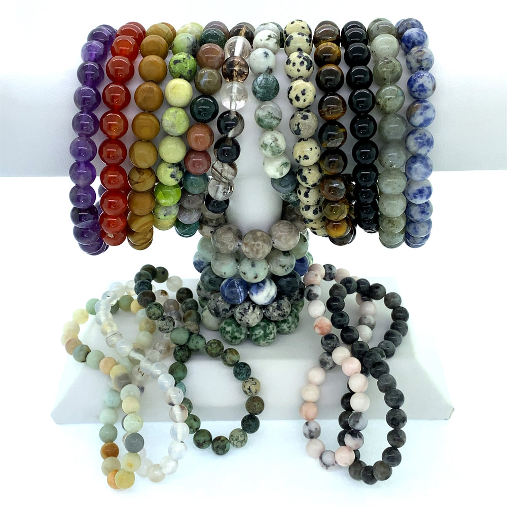 A collection of Super Silver Beaded Stone Bracelets.