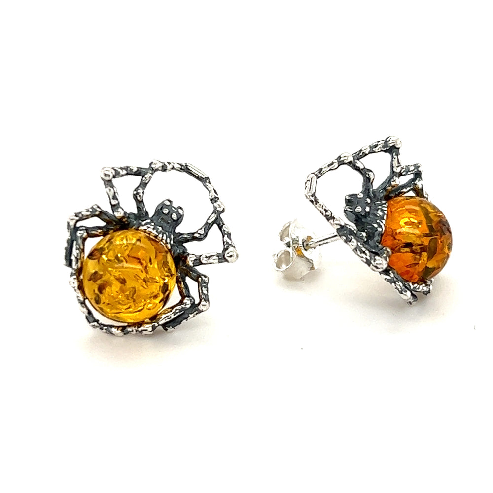 A pair of self-empowerment Eerie Amber Spider Stud Earrings from the Super Silver brand.