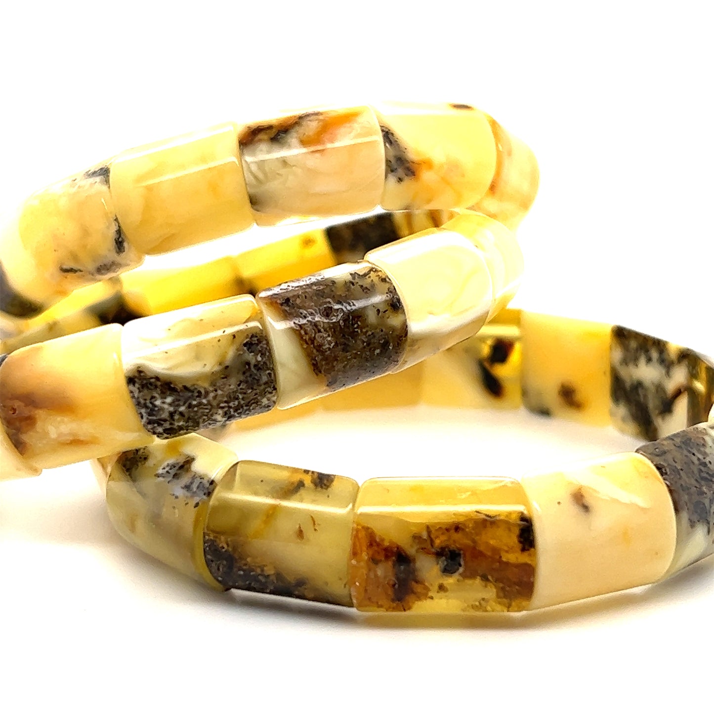 
                  
                    A pair of Brilliant Butterscotch Amber Stretch Bracelets made with yellow and black amber by Super Silver.
                  
                