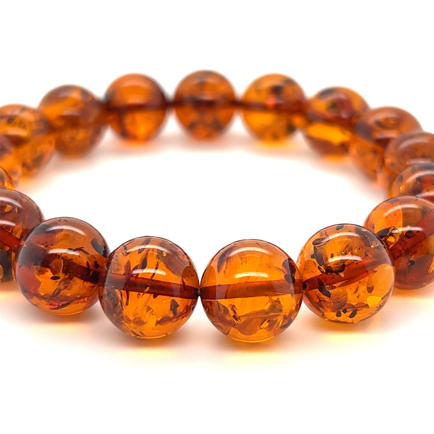 The Captivating Classic Amber Bead Bracelet showcases polished cognac amber beads, expertly arranged in a circle, offering both grounding properties and an elegant touch.