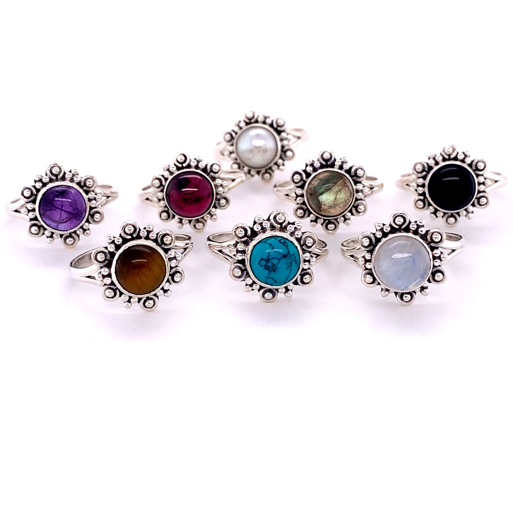 A collection of Beautiful Round Flower Rings with Natural Gemstones adorned with vibrant cabochon stones.