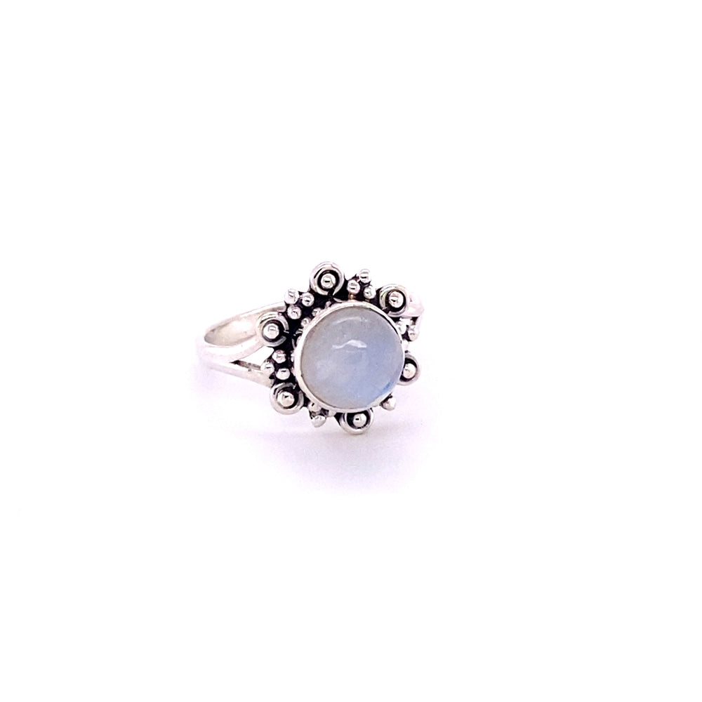 
                  
                    A Beautiful Round Flower Ring with Natural Gemstones with a blue stone in the center.
                  
                