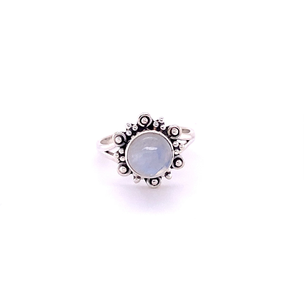 
                  
                    A Beautiful Round Flower Ring with Natural Gemstones with a blue stone in the center.
                  
                