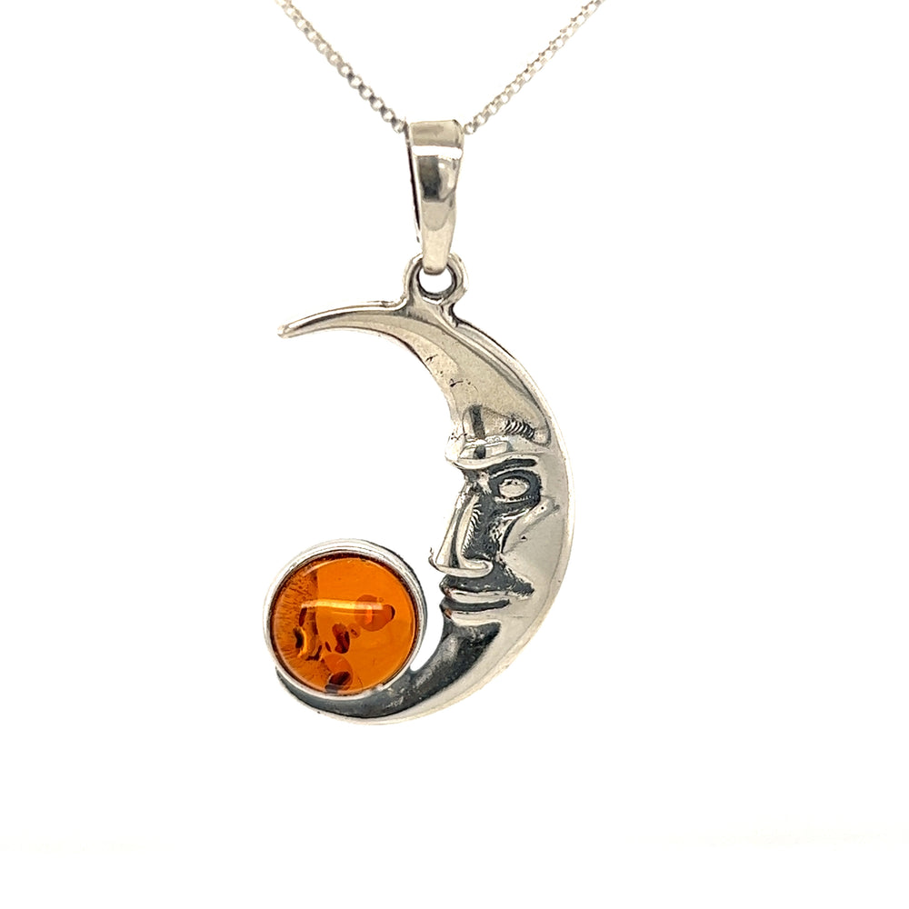 A Super Silver Baltic Amber Man in the Moon Pendant featuring a beautiful crescent moon and adorned with an exquisite amber stone.