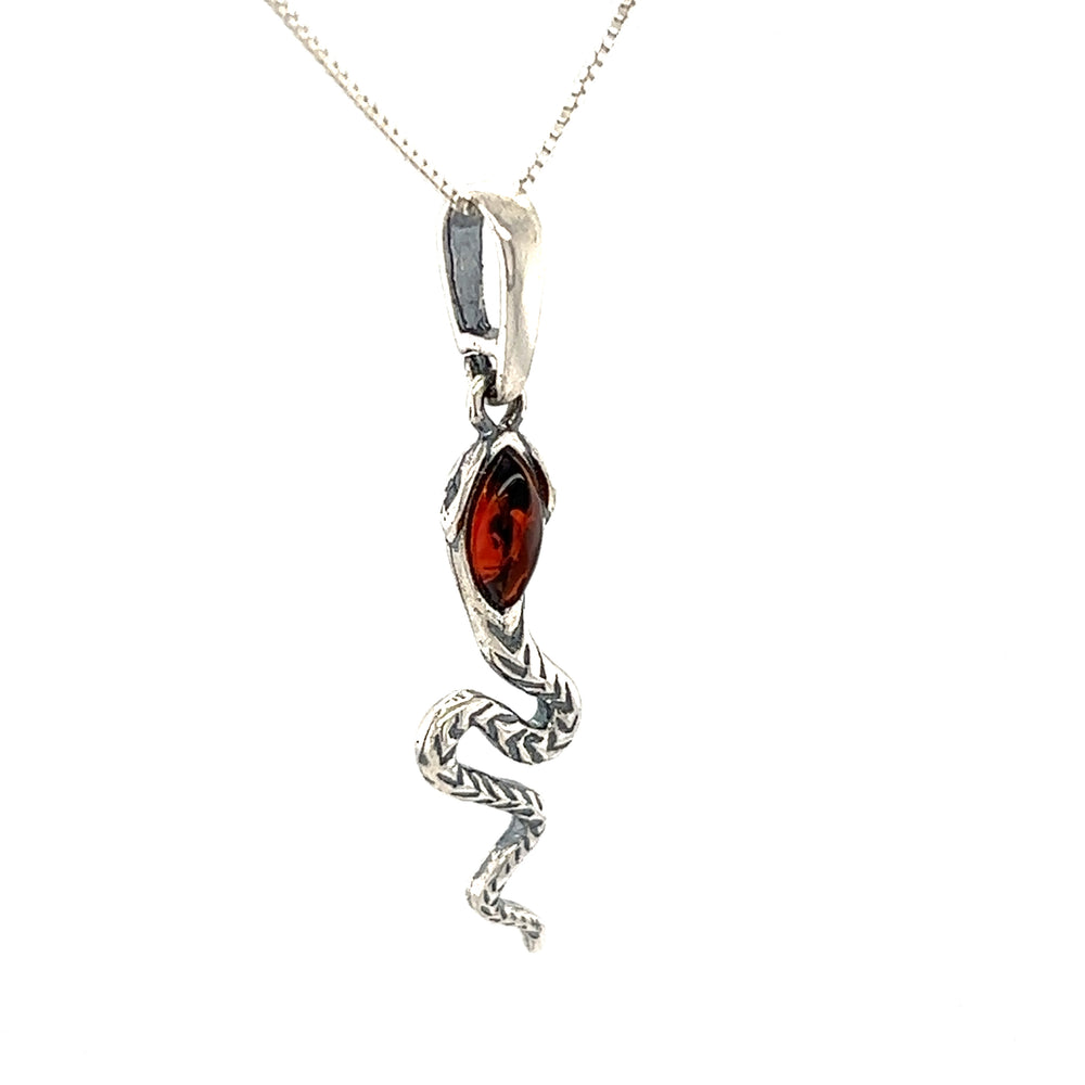 An Alluring Amber Snake Pendant from Super Silver with a red stone encrusted on it.