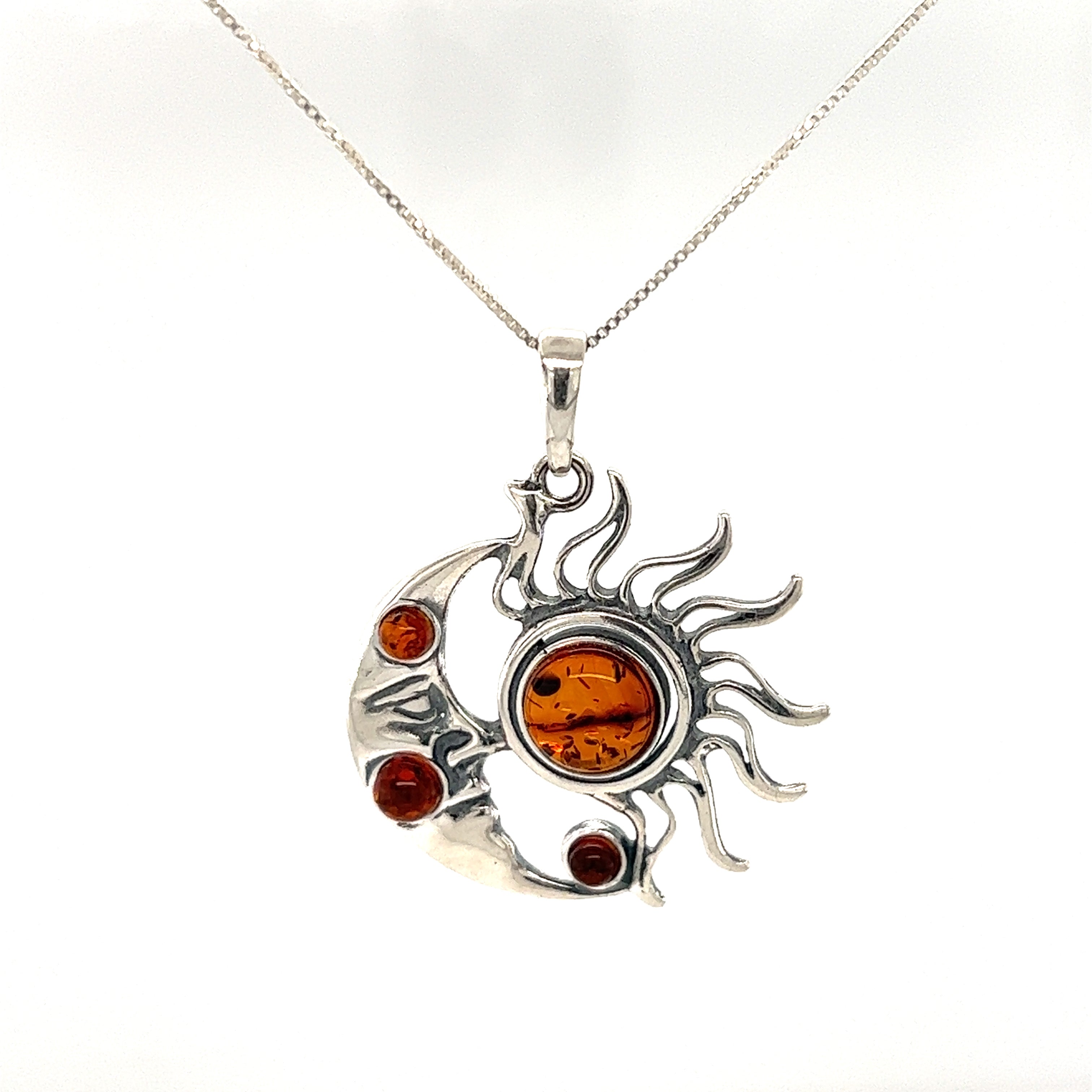 A beautiful Magical Sun and Moon Amber Pendant featuring celestial bodies - the sun and moon by Super Silver.