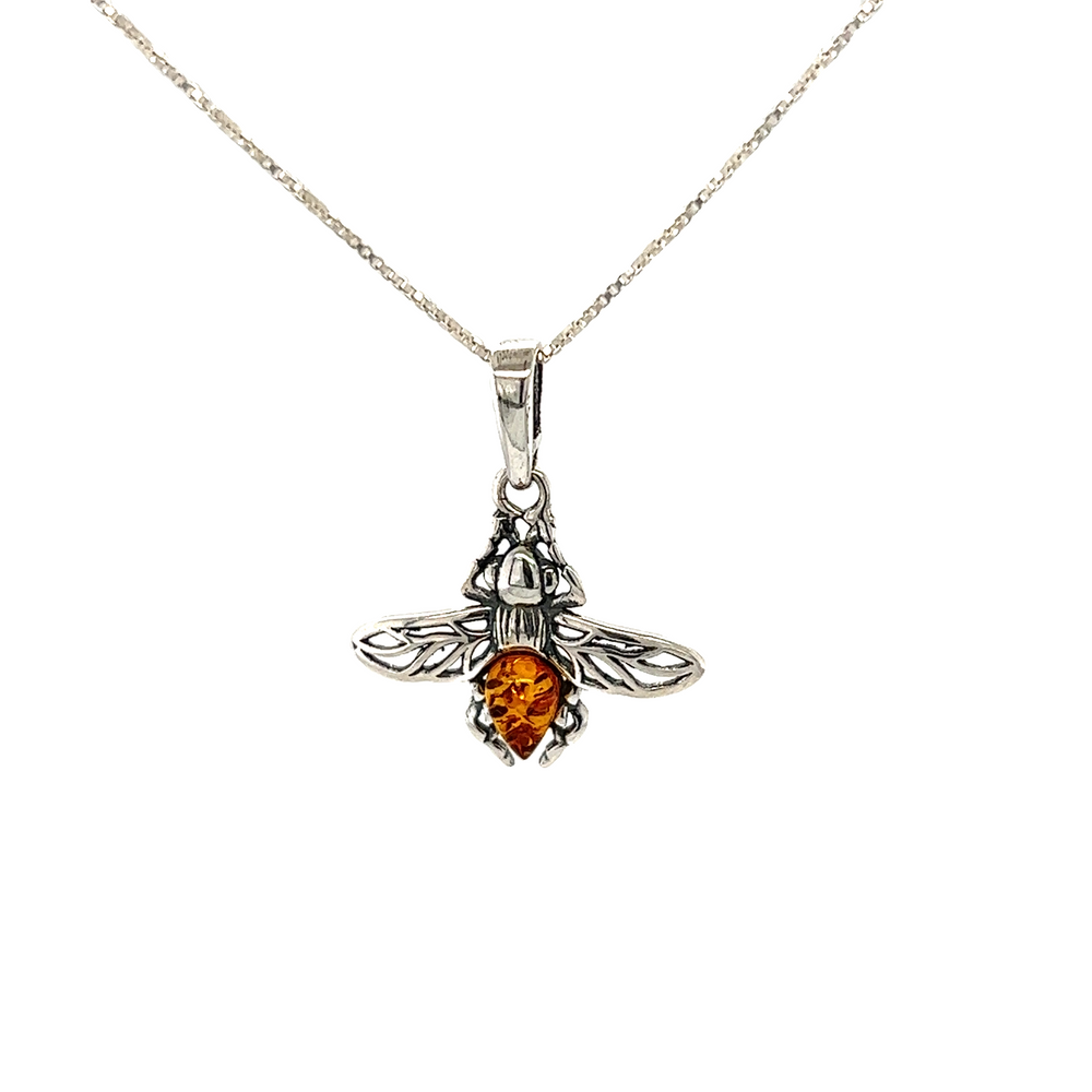 
                  
                    A Delicate Amber Bee Pendant with a baltic amber stone by Super Silver.
                  
                