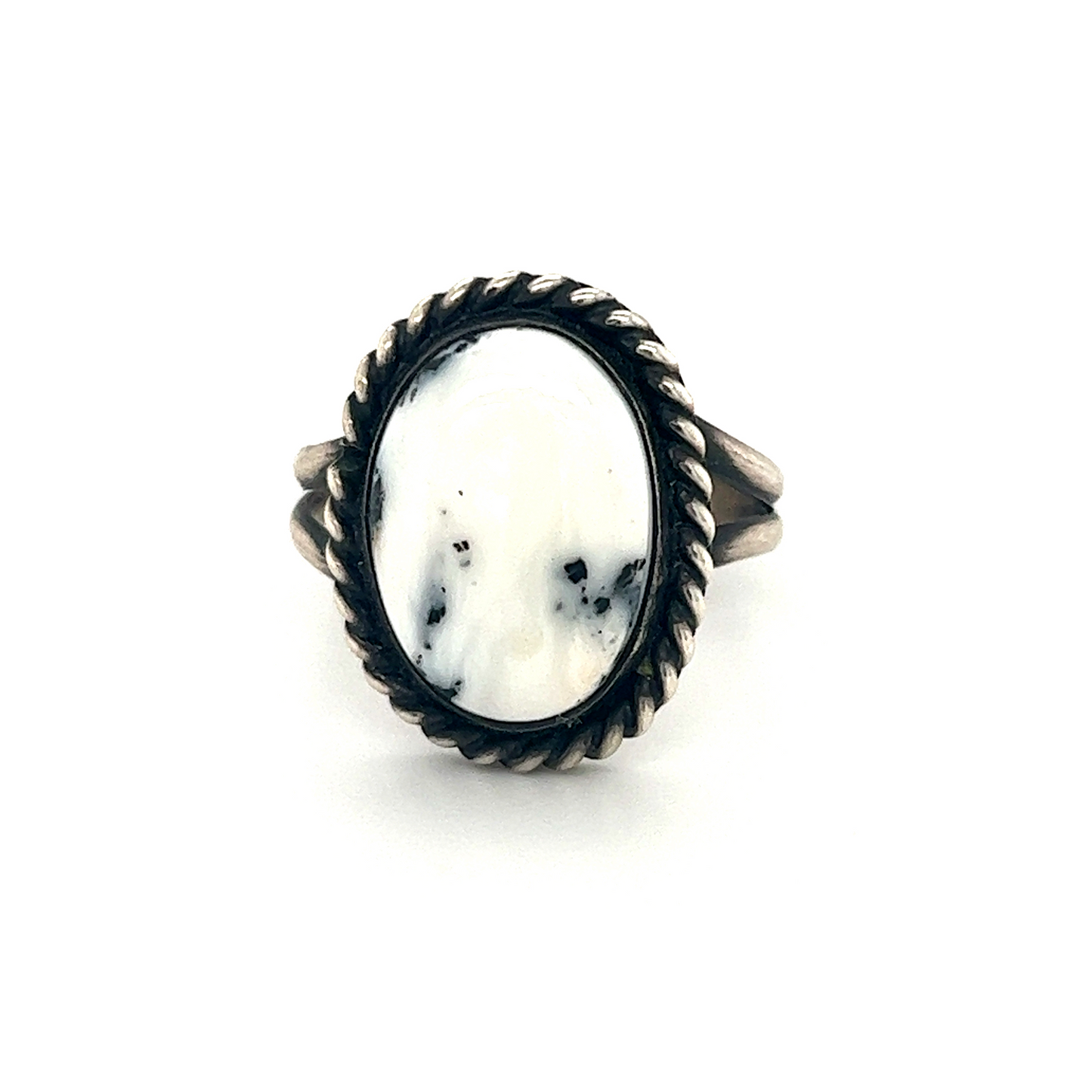 A cultural Unique White Buffalo Turquoise ring with a white stone in the center.