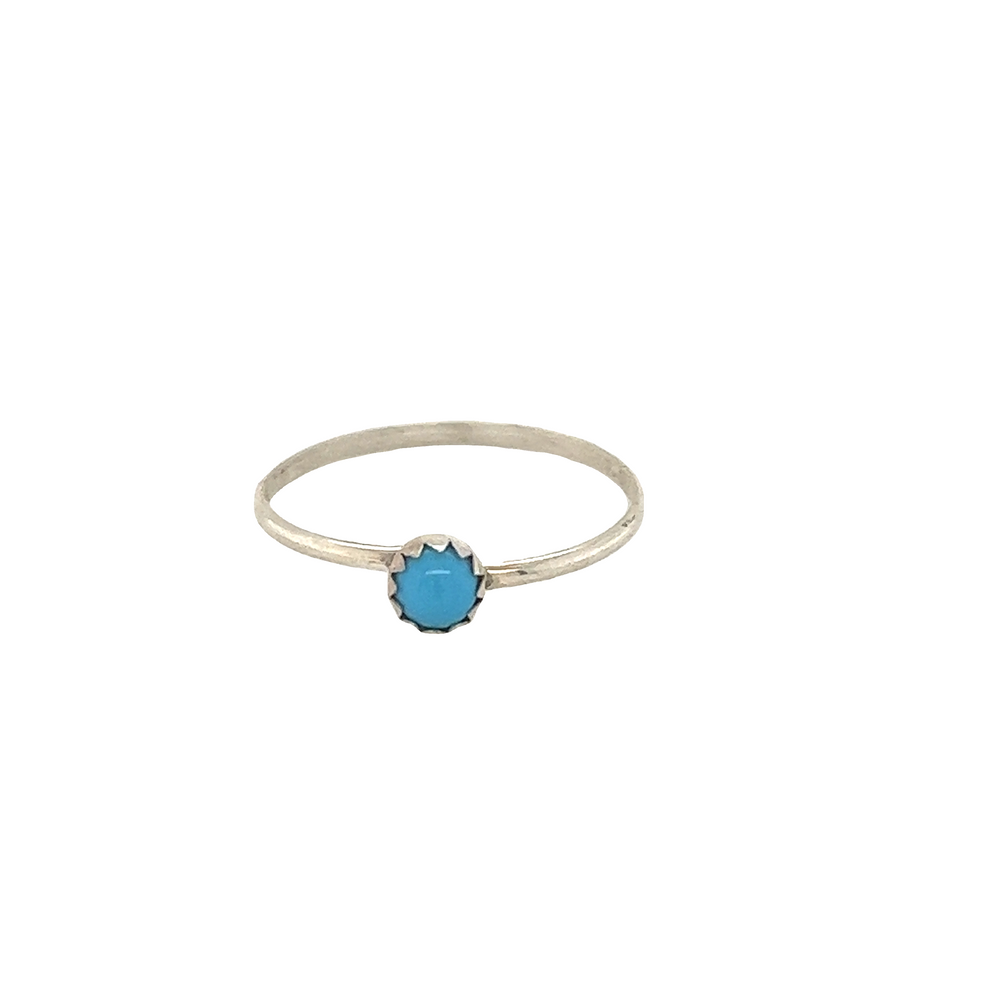 A small Tiny Handcrafted Turquoise Ring with cultural significance on a white background.