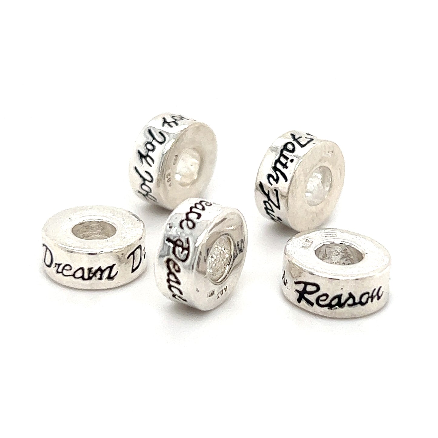 
                  
                    Four Super Silver Affirmation Bead Charms with the words 'dream' and 'reason'.
                  
                