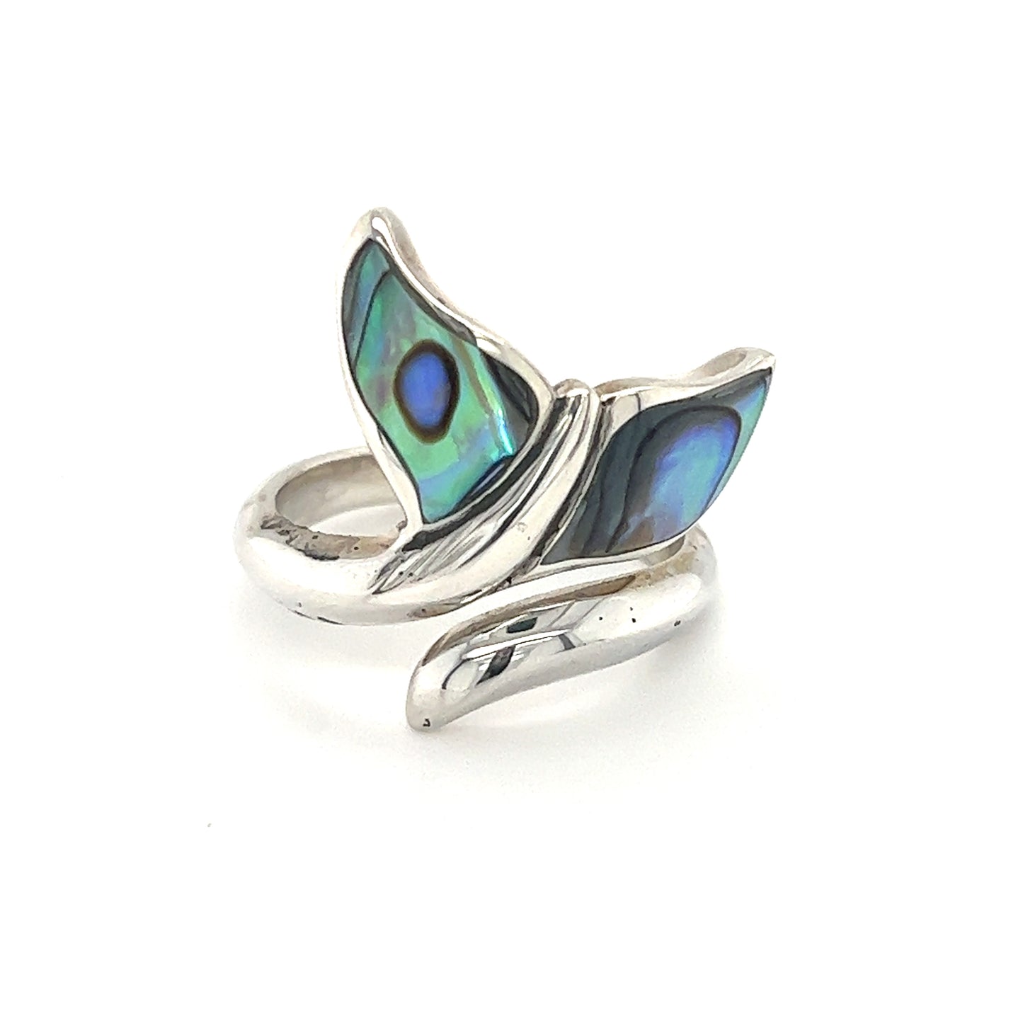 A Refreshing Adjustable Abalone Whale Tail Ring elegantly adorning it, reminiscent of the ocean breeze in Santa Cruz.