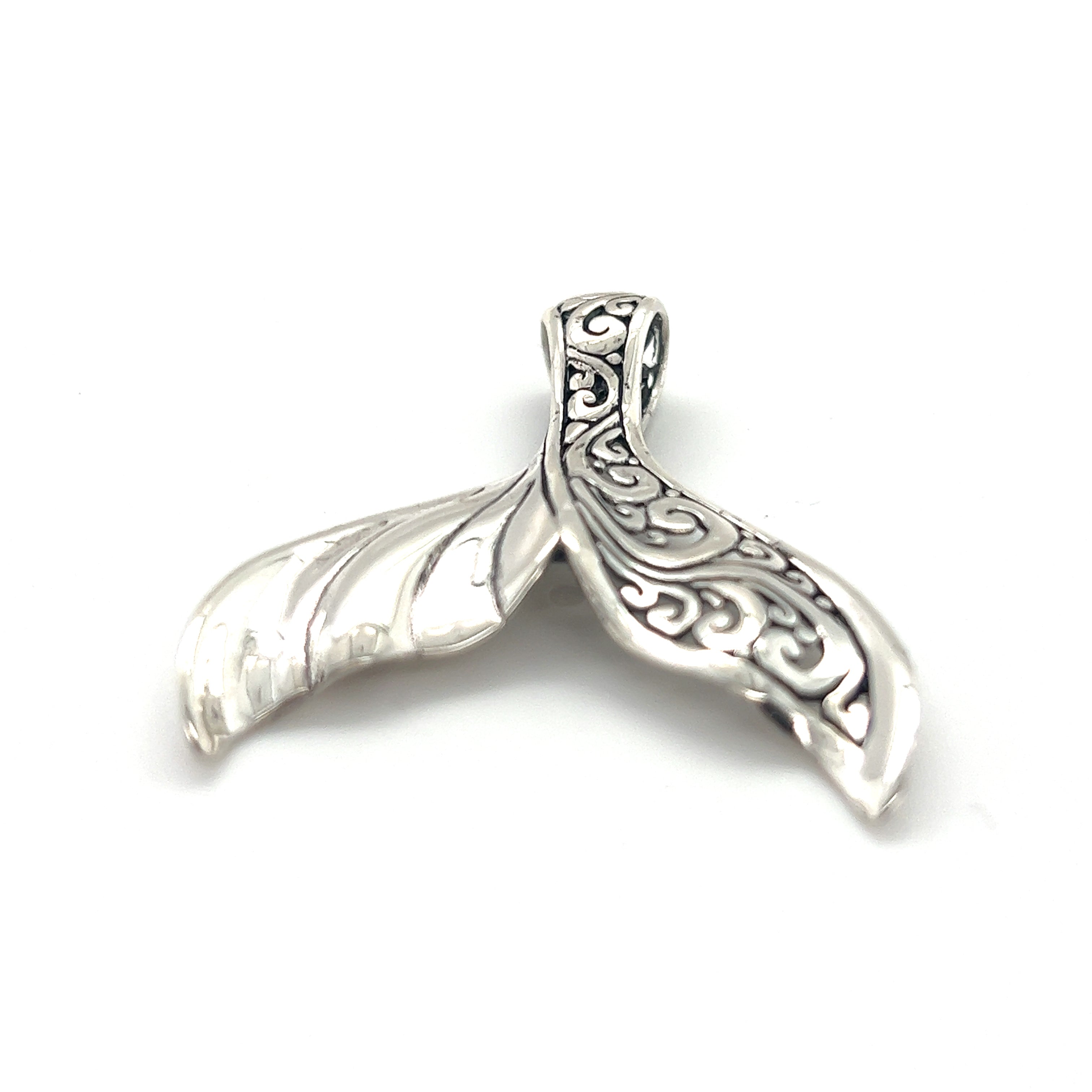 An Exceptional Half Filigree Whale Tail Pendant by Super Silver on a white background in Santa Cruz.