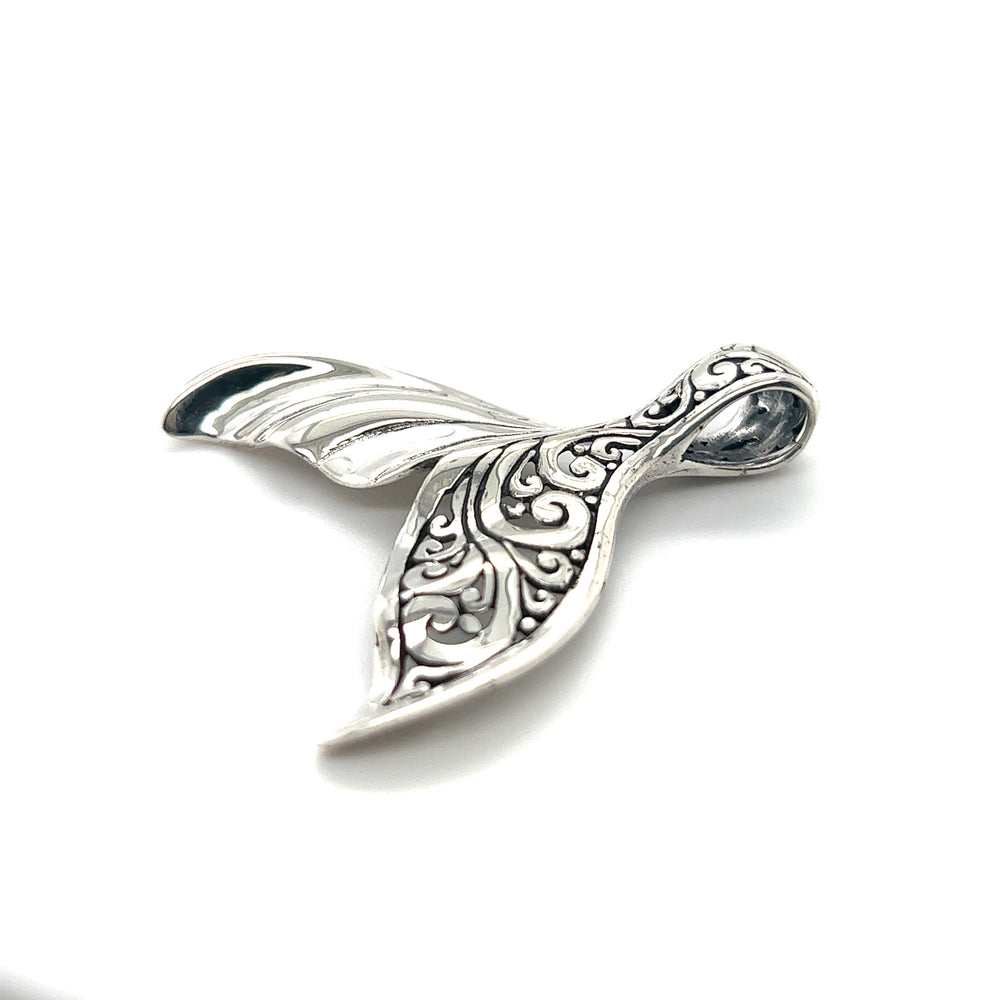 An Exceptional Half Filigree Whale Tail Pendant by Super Silver on a white surface.