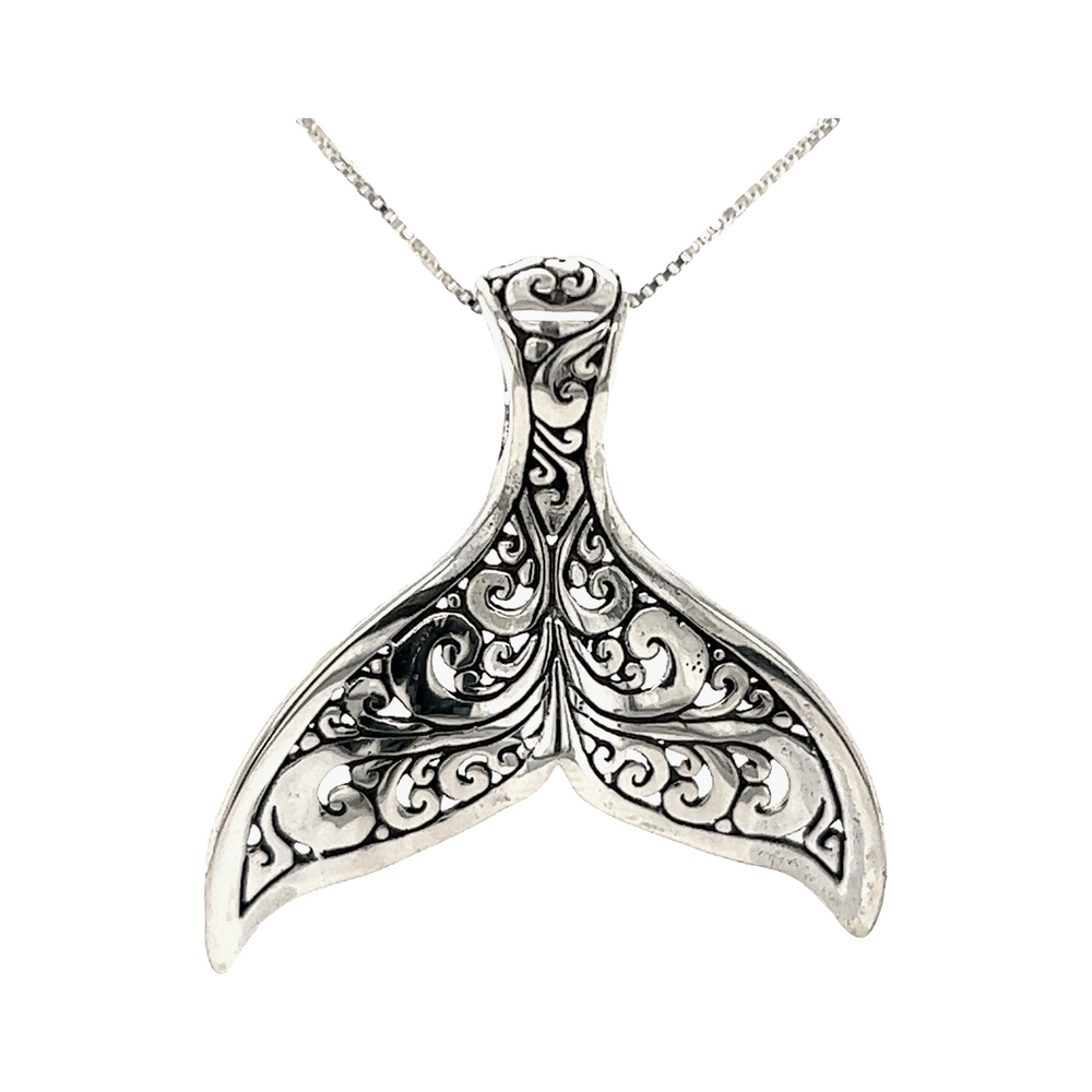 An ornate Super Silver Stunning Full Filigree Whale Tail Pendant on a chain, inspired by the majestic ocean of Santa Cruz.